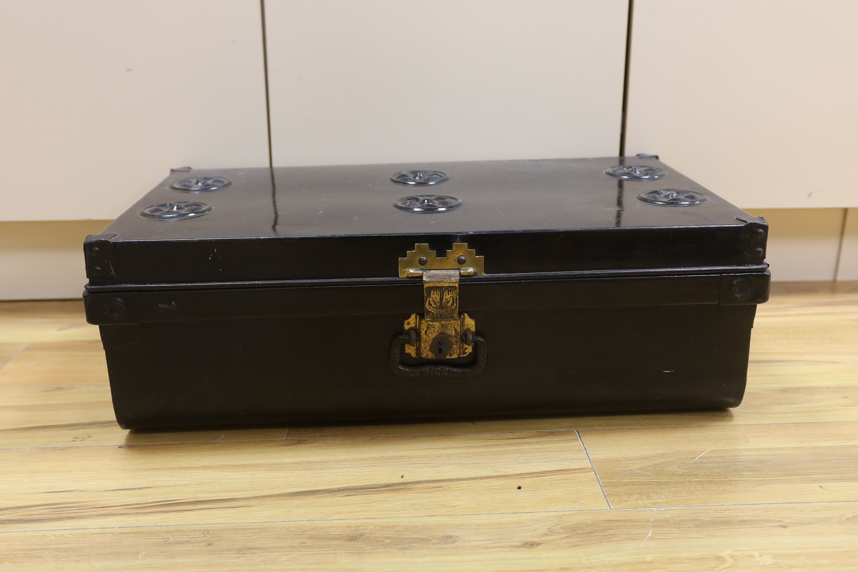 A black lacquered tin trunk, 68cm wide